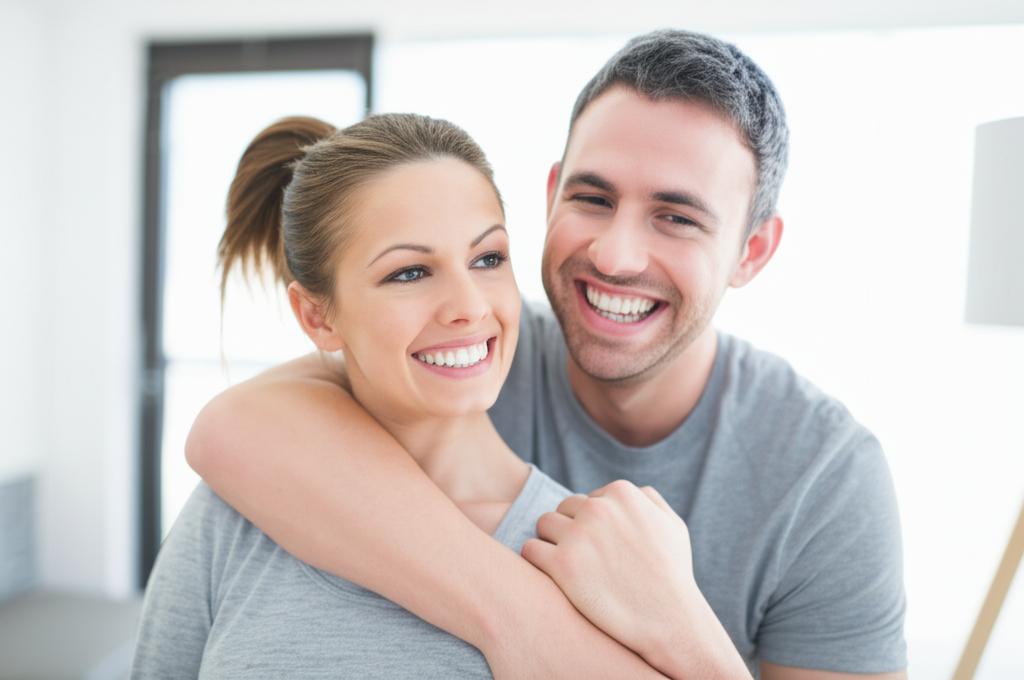 a smiling couple embracing each other, looking happy and energetic