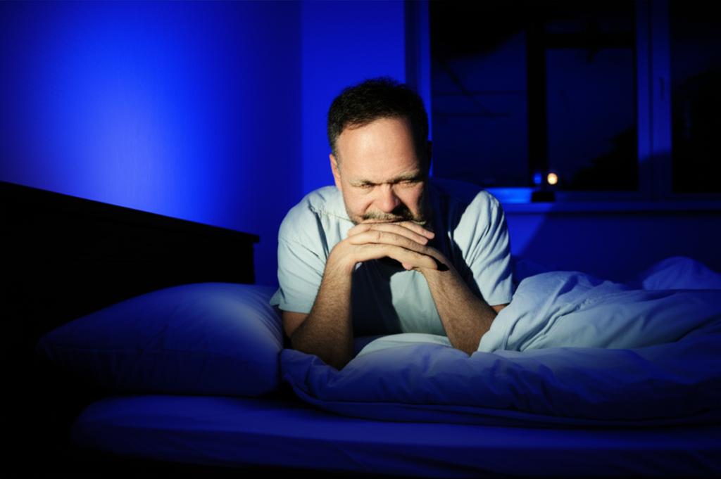 tired middle aged man waking up at night to pee